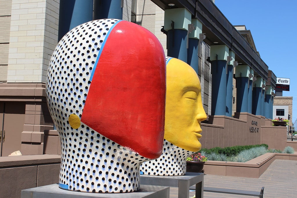 Photo of two art sculptures in the shapes of heads.