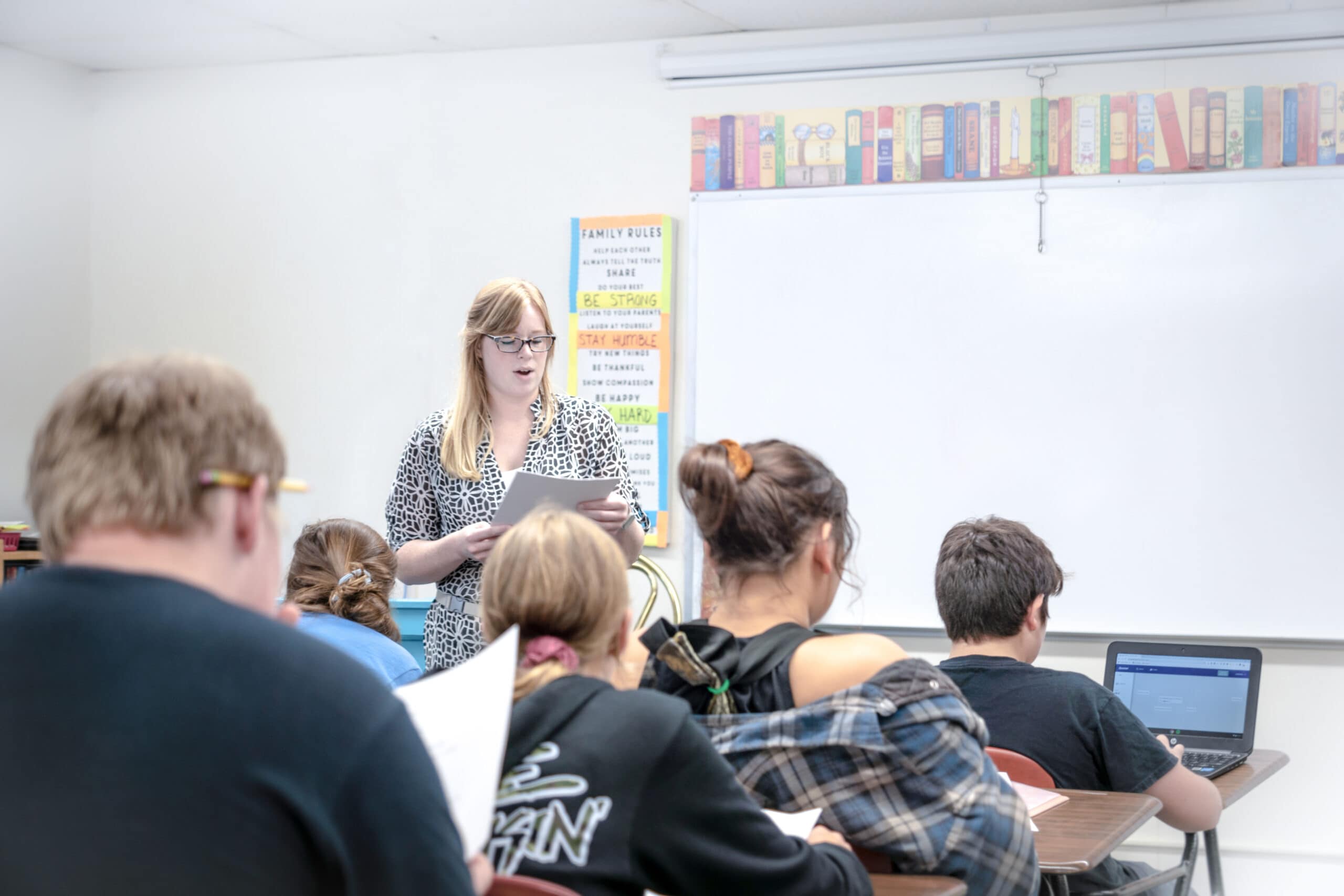 Photo of a teacher speaking to a classroom of students.